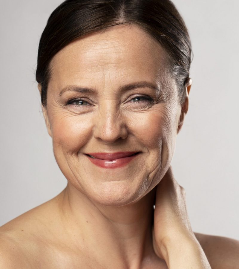 front-view-smiley-mature-woman-posing-with-make-up